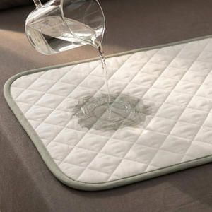 Water poured onto the BESIDE layer, absorbing into the quilted surface